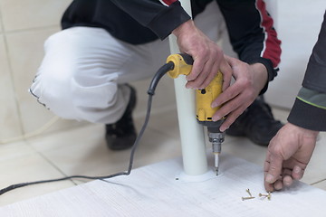 Image showing repairman working with drilling machine