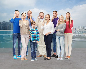 Image showing group of smiling people with smartphones