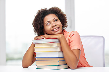 Image showing happy african student girl with books at home