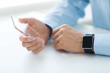 Image showing close up of hands with smart phone and watch