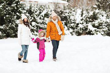 Image showing happy family in winter clothes walking outdoors