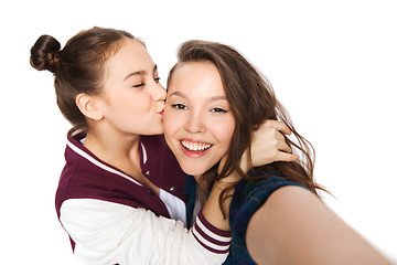 Image showing happy teenage girls taking selfie and kissing