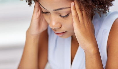 Image showing close up of african young woman touching her head