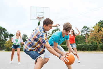 Image showing group of happy teenagers playing basketball