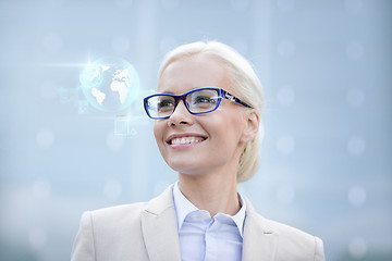 Image showing young smiling businesswoman in eyeglasses outdoors