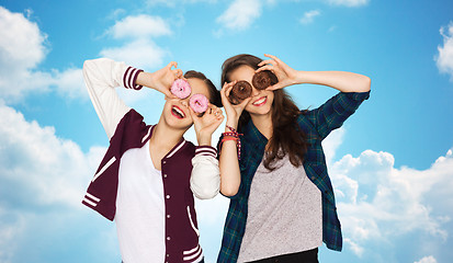 Image showing happy pretty teenage girls with donuts having fun