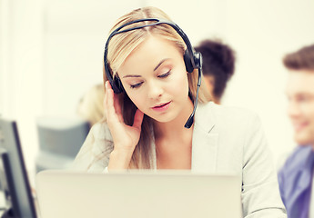 Image showing helpline operator with headphones in call centre