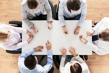 Image showing close up of business team sitting at table