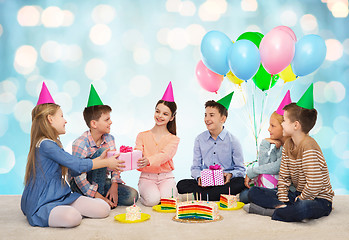 Image showing happy children giving presents at birthday party