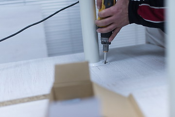 Image showing repairman working with drilling machine