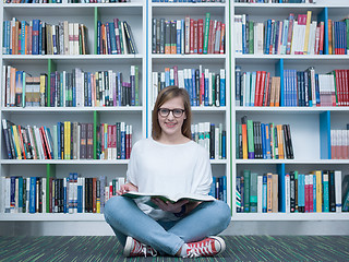 Image showing student girl reading book in library