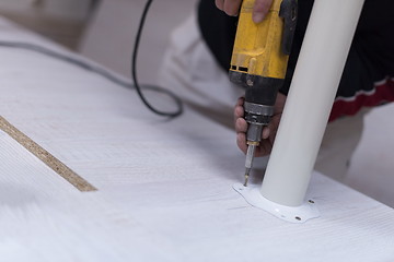 Image showing repairman working with drilling machine