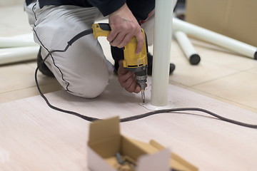 Image showing repairman working with drilling machine