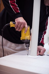 Image showing repairman working with drilling machine