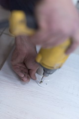 Image showing repairman working with drilling machine