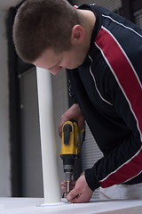 Image showing repairman working with drilling machine