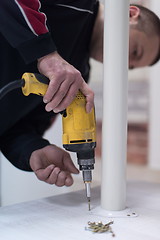 Image showing repairman working with drilling machine