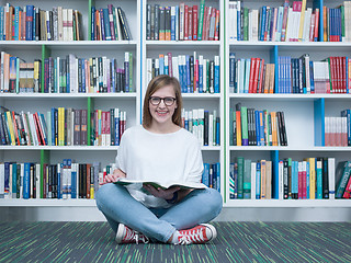 Image showing student girl reading book in library