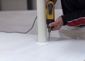 Image showing repairman working with drilling machine