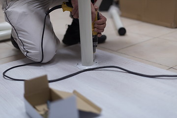 Image showing repairman working with drilling machine