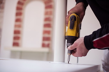 Image showing repairman working with drilling machine