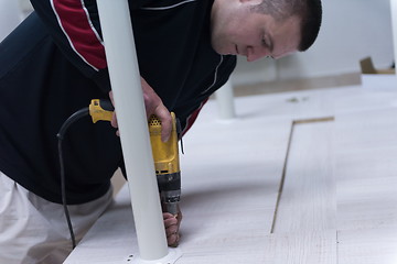 Image showing repairman working with drilling machine