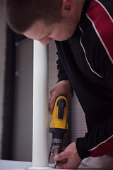 Image showing repairman working with drilling machine