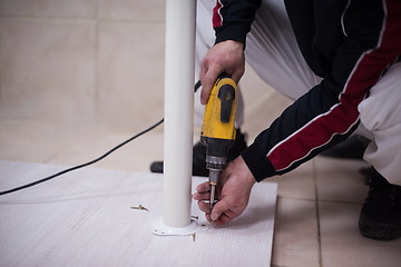 Image showing repairman working with drilling machine