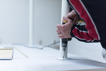 Image showing repairman working with drilling machine