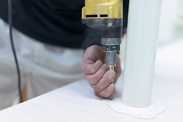 Image showing repairman working with drilling machine