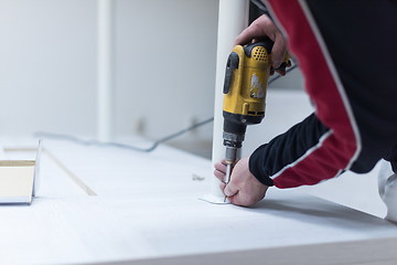 Image showing repairman working with drilling machine