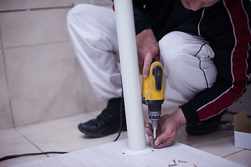 Image showing repairman working with drilling machine