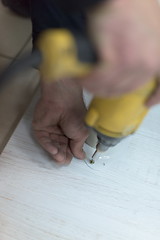 Image showing repairman working with drilling machine