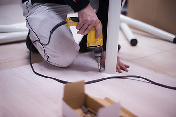 Image showing repairman working with drilling machine