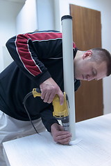 Image showing repairman working with drilling machine