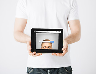 Image showing close up of man with web search bar on tablet pc