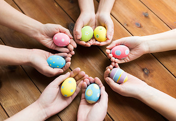 Image showing close up of woman hands with colored easter eggs