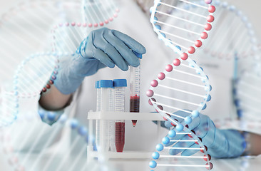 Image showing close up of scientist with tube making test in lab