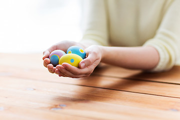 Image showing close up of woman hands with colored easter eggs