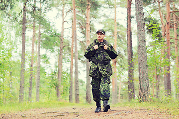 Image showing young soldier with backpack in forest