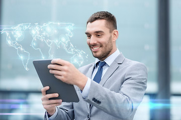 Image showing smiling businessman with tablet pc outdoors