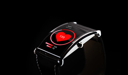 Image showing close up of black smart watch with heart rate icon