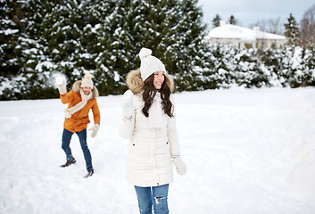 Image showing happy couple playing snowballs in winter