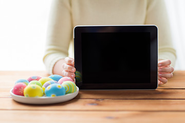 Image showing close up of woman with tablet pc and easter eggs
