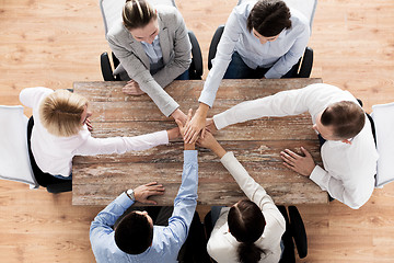 Image showing close up of business team with hands on top