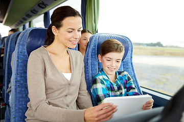 Image showing happy family with tablet pc sitting in travel bus