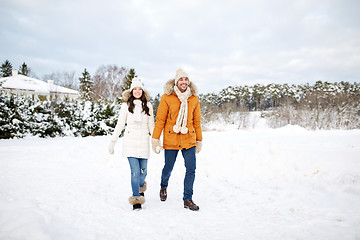 Image showing happy couple walking along snowy winter field