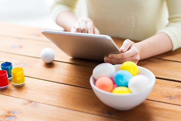 Image showing close up of woman with tablet pc and easter eggs