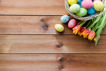 Image showing close up of easter eggs in basket and flowers