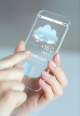 Image showing close up of hands with weather cast on smartphone